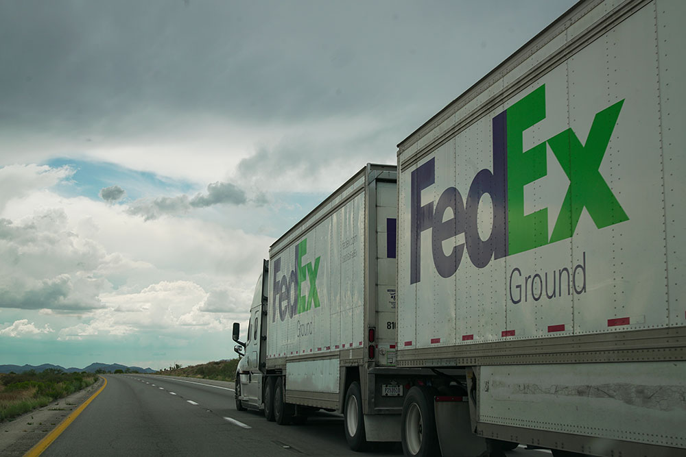 A FedEx delivery truck driving on a highway