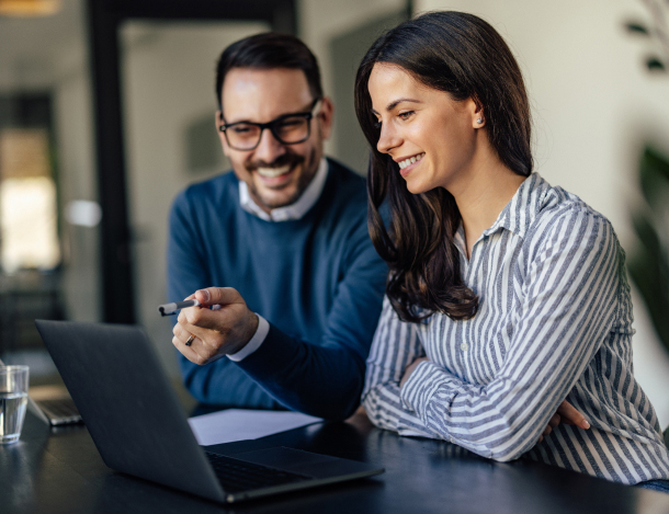 Two team members working together on laptop