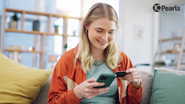 A smiling woman uses a fintech app on her smartphone