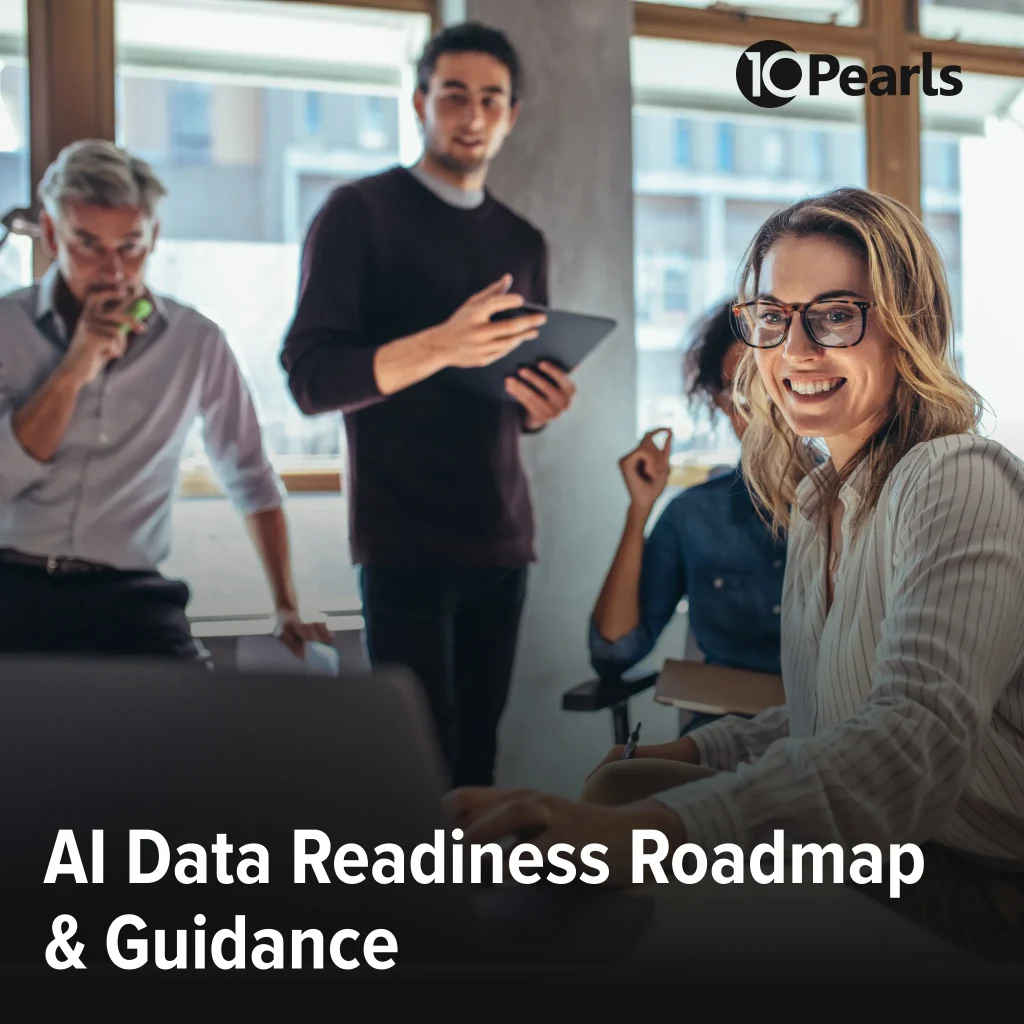 Professional team working together on AI data readiness roadmap, sitting around computer.