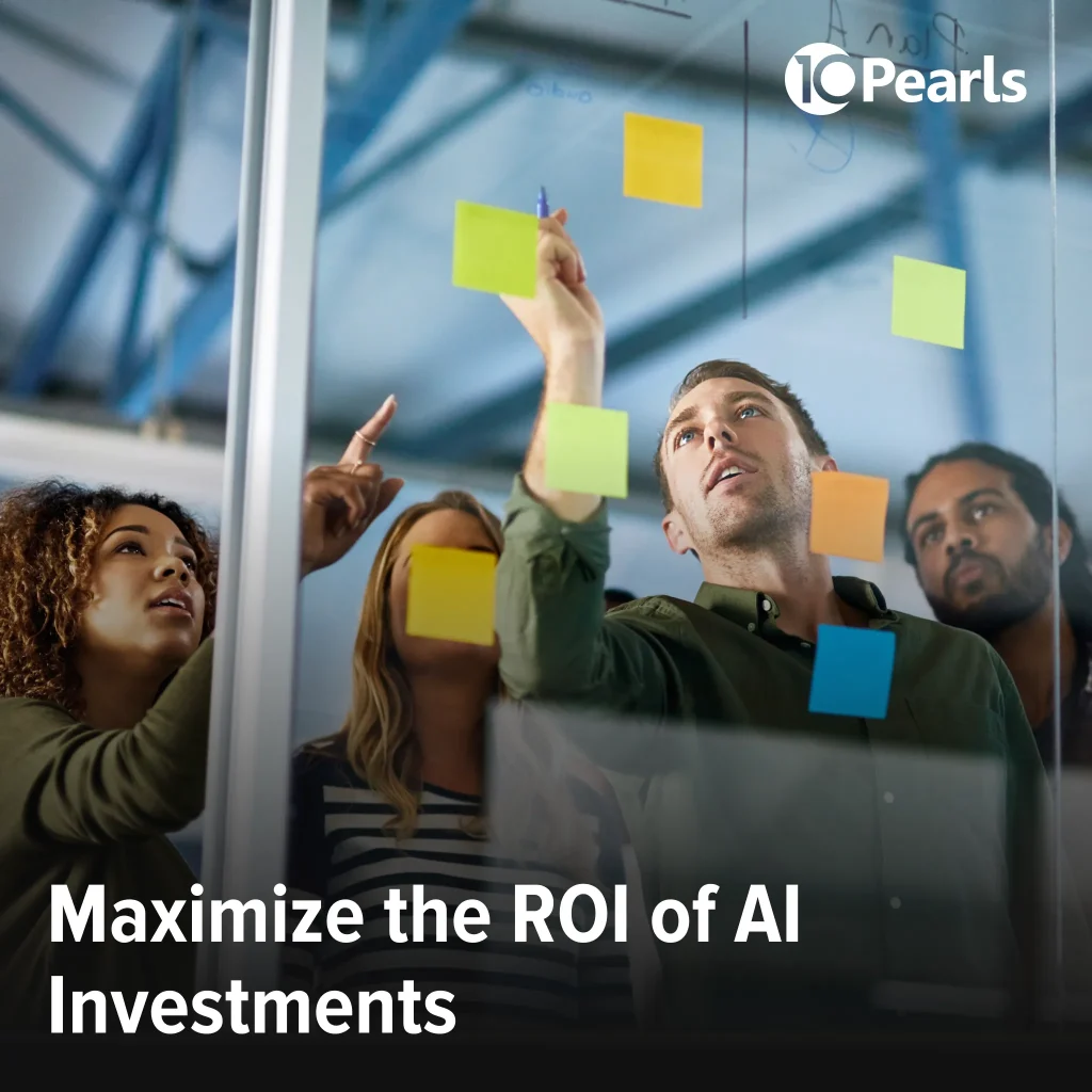 Team of young professionals brainstorming, pasting notes on wall